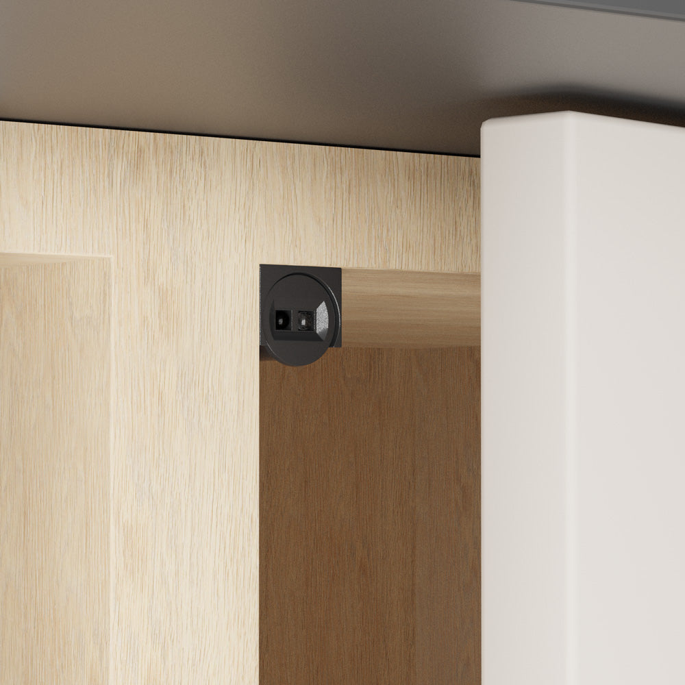 Single head door trigger (IR) sensor switch in black color installed on cabinet door.