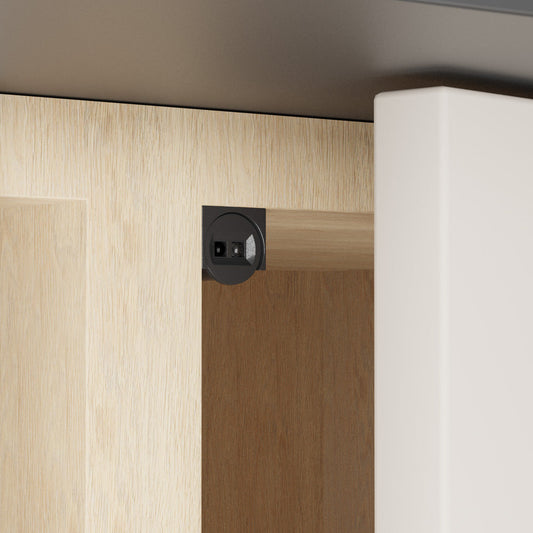 Single head door trigger (IR) sensor switch in black color installed on cabinet door.