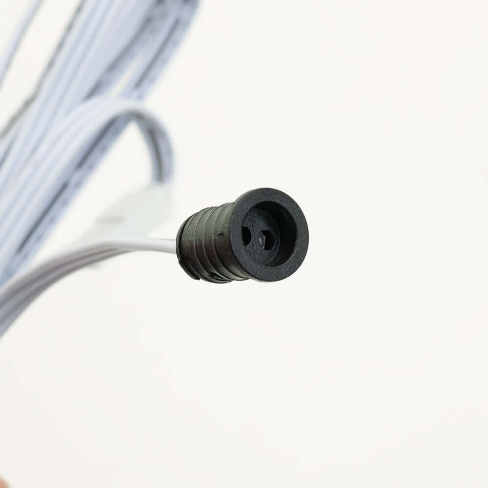 Close-up of a black connector end of a wire, designed for electrical applications and connections.