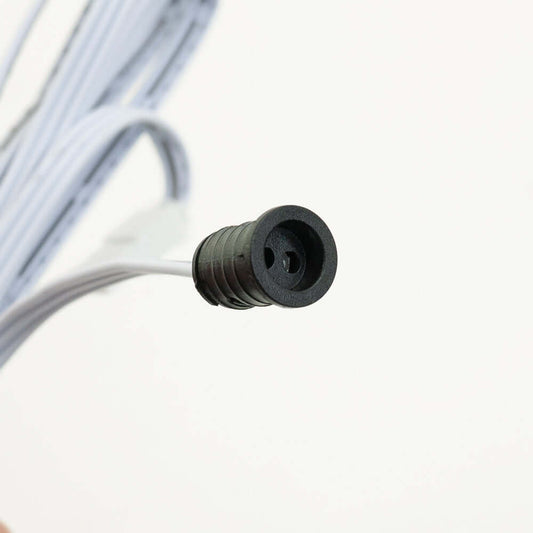 Close-up of a black connector end of a wire, designed for electrical applications and connections.